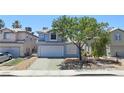 Inviting two-story home with great curb appeal, a manicured front yard, and a two-car garage at 6063 Peach Orchard Rd, Las Vegas, NV 89142