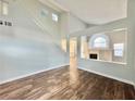 Bright and spacious living room features vaulted ceilings, modern wood flooring, and an open floor plan at 6063 Peach Orchard Rd, Las Vegas, NV 89142