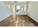 Bright living room showcasing vaulted ceilings, wood-look flooring, and an open floorplan with fireplace at 6063 Peach Orchard Rd, Las Vegas, NV 89142