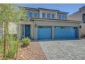 Beautiful two-story home with blue accents, landscaped front yard, and a modern paved driveway at 629 Soaring Wings Ave, Las Vegas, NV 89183