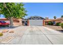 Charming single-story home featuring a two-car garage, desert landscaping, and a mature shade tree at 6924 Senton Ave, Las Vegas, NV 89108