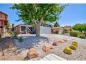Charming single-story home featuring a two-car garage, desert landscaping, and a mature shade tree at 6924 Senton Ave, Las Vegas, NV 89108