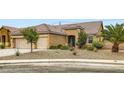 Single-story home featuring desert landscaping, a two-car garage, and a cozy entrance at 7559 Chambery Cove Ct, Las Vegas, NV 89123