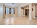 Bright living room with tile flooring, neutral walls, and large windows with natural light at 7559 Chambery Cove Ct, Las Vegas, NV 89123