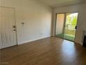 Inviting living room with wood floors and a sliding glass door leading to outdoor patio with faux grass at 7885 W Flamingo Rd # 2129, Las Vegas, NV 89147