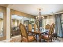 Elegant dining room boasts a chandelier, large table, and an open view of the living room at 11241 Pentland Downs St, Las Vegas, NV 89141