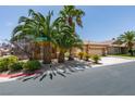 Charming single-story home with a three-car garage and tropical landscaping at 1453 Doggett Ave, Las Vegas, NV 89123