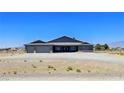 Attractive single-story house featuring a two-car garage and desert landscaping at 1830 Justine Ct, Pahrump, NV 89048