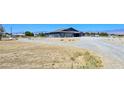 Spacious lot with a single-story house and large driveway at 1830 Justine Ct, Pahrump, NV 89048