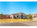 Beautiful single-story home with stone accents, desert landscaping, and a gated yard at 211 E Kimberly Dr, Henderson, NV 89015