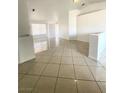 Bright living room with tile floors and large windows, offering a clean and modern feel at 2405 Prime Advantage Ave, North Las Vegas, NV 89032