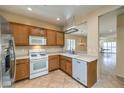 Well-lit kitchen features oak cabinets and a gas range stove at 2540 Binary Stars St, Henderson, NV 89044