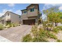 Two-story home with a brick driveway, desert landscaping, and an attached two-car garage at 2732 Roman Palm Rd, North Las Vegas, NV 89086