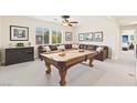 Entertaining game room featuring a pool table, comfortable seating, and tasteful decorations for leisure and recreation at 2755 Asgard Ave, Las Vegas, NV 89121