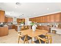 Spacious kitchen with wood cabinets, a central island with bar seating, and modern appliances for culinary enthusiasts at 2755 Asgard Ave, Las Vegas, NV 89121