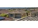 An elevated view highlights this tan home's roof within a vibrant neighborhood and distant city skyline at 2856 Trossachs St, Henderson, NV 89044