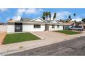 Attractive single-Gathering home with vibrant green lawn and a large driveway for multiple vehicles at 2990 Carnelian St, Las Vegas, NV 89121