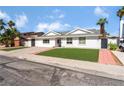 Inviting single-story house showcasing fresh landscaping and a quaint walkway leading to the front door at 2990 Carnelian St, Las Vegas, NV 89121