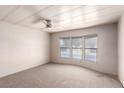 Spacious carpeted bedroom filled with natural light from the large bay window at 3471 Cape Cod Dr, Las Vegas, NV 89122