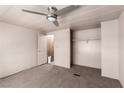 Carpeted bedroom featuring a ceiling fan, closet, and access to the en-suite bathroom at 3471 Cape Cod Dr, Las Vegas, NV 89122