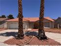 Home featuring an orange tile roof, desert landscaping, and mature palm trees at 3644 Valley Dr, North Las Vegas, NV 89032