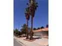 Nice home featuring an orange tile roof, two tall palm trees, and desert landscaping at 3644 Valley Dr, North Las Vegas, NV 89032