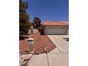 Ranch-style home with driveway, desert landscaping, tile roof and mailbox at 3644 Valley Dr, North Las Vegas, NV 89032