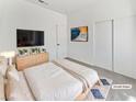 Modern bedroom with minimalist decor, a large bed, and a sliding-door closet at 3804 Wren Ct, North Las Vegas, NV 89032
