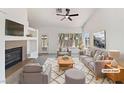 Bright living room with a fireplace, large windows, neutral decor, and ample seating at 3804 Wren Ct, North Las Vegas, NV 89032