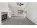 Bright living room with a fireplace, large windows, and neutral carpet and paint at 3804 Wren Ct, North Las Vegas, NV 89032