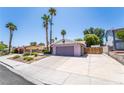 Charming single-story home featuring a two-car garage, extended driveway, and mature palm trees at 4129 Ridgewood Ave, Las Vegas, NV 89120