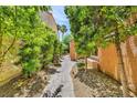 A tranquil side yard featuring a stone pathway and verdant trees at 5123 Southern Hills Ln, Las Vegas, NV 89113
