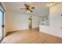 Open concept living area with neutral walls, tiled floors, and a ceiling fan at 5650 E Sahara Ave # 1001, Las Vegas, NV 89142