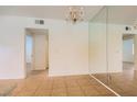 Bright living space featuring tile flooring, a chandelier, and a mirrored wall at 5650 E Sahara Ave # 1001, Las Vegas, NV 89142