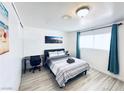 Neutral bedroom features a desk, artwork, and plenty of natural light at 5821 Marka Dr, Las Vegas, NV 89108