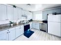 Updated kitchen with stainless steel appliances, granite counters, and blue cabinets at 5821 Marka Dr, Las Vegas, NV 89108