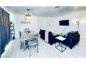 Comfortable living room area features a dining table and a mounted TV at 5821 Marka Dr, Las Vegas, NV 89108