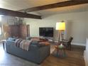 Cozy living room with a brick fireplace, comfortable seating, and modern flooring at 6409 Burgundy Way, Las Vegas, NV 89107