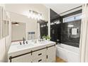 Modern bathroom showcasing a double vanity, sleek mirrors, and a shower-tub combo at 68 Belle Soleil Ave, Las Vegas, NV 89123
