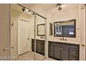 Bathroom featuring dual sink vanity with decorative mirrors and modern lighting at 722 Barrie Ct, Henderson, NV 89002