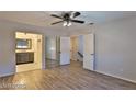 Bright bedroom featuring wood floors, a ceiling fan, and mirrored closet doors at 722 Barrie Ct, Henderson, NV 89002