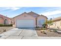 Charming single-story home with a two-car garage, desert landscaping, and concrete driveway at 7920 Turtle Island Ct, Las Vegas, NV 89129