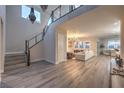 Open-concept living area with high ceilings, modern staircase, hardwood floors and contemporary lighting at 8984 Rolling Pietra St, Las Vegas, NV 89166