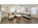 Spacious living room featuring comfortable seating, natural light, and open-concept layout with luxury vinyl plank at 9205 Valley Betica Ave, Las Vegas, NV 89148