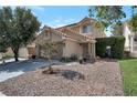 Attractive home showcasing a well-manicured lawn, beautiful landscaping, and a cozy covered porch at 9449 Amber Valley Ln, Las Vegas, NV 89134