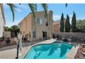 Inviting backyard features a sparkling pool with a spa, perfect for outdoor entertaining and relaxation at 9449 Amber Valley Ln, Las Vegas, NV 89134