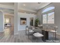 Elegant dining area featuring modern decor, a glass top table, with easy access to the living room and kitchen at 950 Marbelwood Ave, Las Vegas, NV 89123