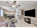 Comfortable living room with tile flooring, a ceiling fan, and easy access to the kitchen at 967 Coronado Peak Ave, Las Vegas, NV 89183