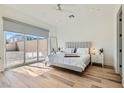 Bright bedroom with large windows, light wood floors, and a neutral color palette create a serene and modern living space at 10239 Meandering Dell Ave, Las Vegas, NV 89166