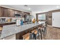 Modern kitchen with granite countertops, stainless steel appliances, and seating at the breakfast bar at 12280 Golden Wreath Rd # 3, Las Vegas, NV 89183